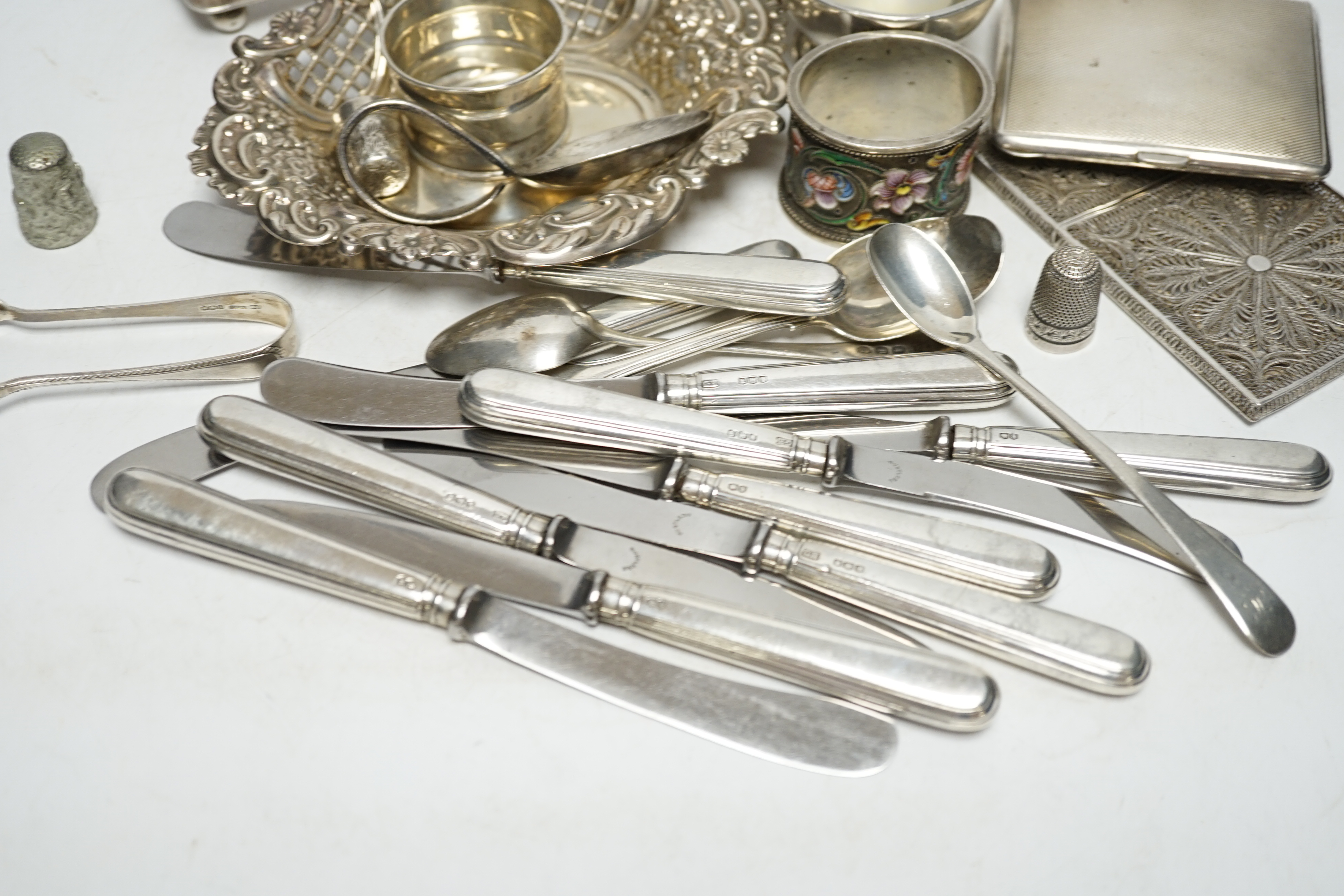 A quantity of assorted silver ad white metal items including a Russian 84 zolotnik and cloisonné enamel napkin ring, bon bon dish, scent bottle, cutlery, toast rack, cigarette case etc. Condition - fair to poor